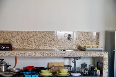 a kitchen with a counter top with a sink and a stove at Le Calme a Temara in Temara