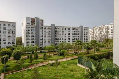 a park in front of a large apartment building at TT Holidays Hay Riad Prestigia in Rabat