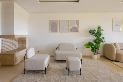 a room with three chairs and a couch and a table at TT Holidays Hay Riad Prestigia in Rabat
