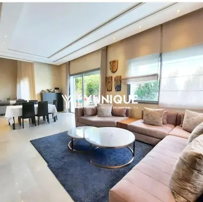 a living room with a couch and a table at Villa de Luxe piscine privée in Casablanca
