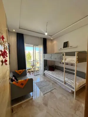 a room with two bunk beds and a couch at Shems Bouznika kettani in Bouznika