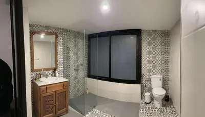 a bathroom with a sink and a toilet and a mirror at Appartement loft de luxe dans un quartier Art Déco en plein centre de Casablanca in Casablanca