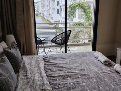a bedroom with a bed and a large window at Parc Nouaceur in Nouaseur