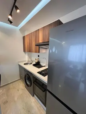 a kitchen with a stainless steel refrigerator and a stove at Au centre de Casablanca maarif in Casablanca