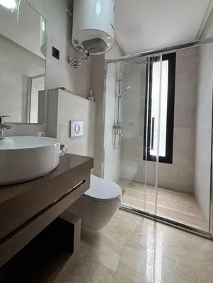 a bathroom with a sink and a toilet and a shower at Au centre de Casablanca maarif in Casablanca