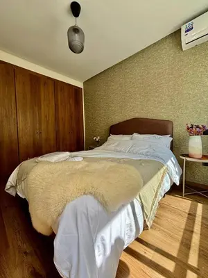 a bedroom with a large bed with white sheets at Au centre de Casablanca maarif in Casablanca