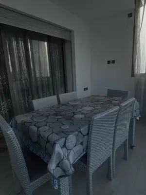 a room with a table and chairs and a table and chairs at Appartement sur SIDI Rahal in Casablanca