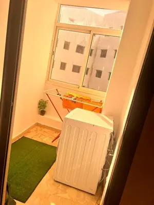 a small room with a green rug and a window at Studio Cosy Centre Ville Casablanca in Casablanca