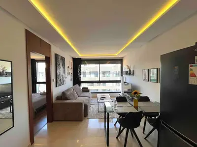 a living room with a couch and a table at Tour 33 : Appartement chic en plein cœur de Casa in Casablanca