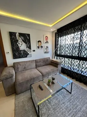 a living room with a couch and a coffee table at Tour 33 : Appartement chic en plein cœur de Casa in Casablanca