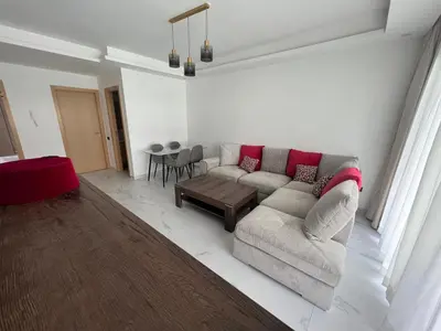 a living room with a couch and a table at ZS house harhoura vue sur piscine in Temara