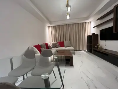 a living room with a couch and a table at ZS house harhoura vue sur piscine in Temara