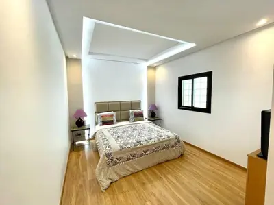 a bedroom with a bed in a white room at Villa Havre De Paix à Casablanca in Casablanca