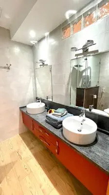 a bathroom with two sinks and a large mirror at Villa Havre De Paix à Casablanca in Casablanca