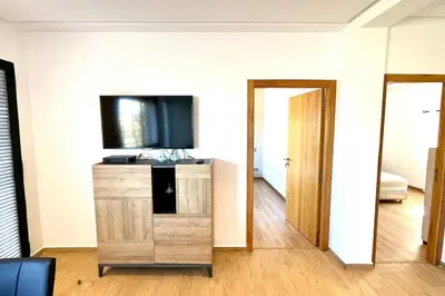 a living room with a tv and a wooden cabinet at Villa Havre De Paix à Casablanca in Casablanca