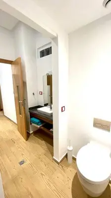a bathroom with a white toilet and a sink at Villa Havre De Paix à Casablanca in Casablanca