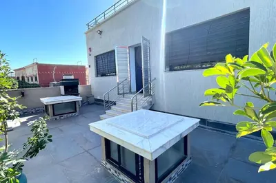 a patio with a table and benches on a building at Villa Havre De Paix à Casablanca in Casablanca