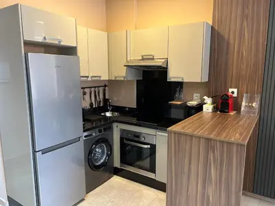 a kitchen with a refrigerator and a stove top oven at Studio cosy chic in Casablanca