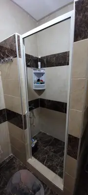 a shower with a glass door in a bathroom at Bel appartement avec vue sur mer Sidi Rahal in Sidi Rahal