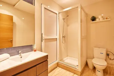 a bathroom with a shower and a toilet and a sink at Serene One Bed Oasis in the Heart Of The Medina in Les Camps