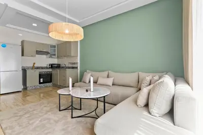 a living room with a couch and a table at Serene One Bed Oasis in the Heart Of The Medina in Les Camps
