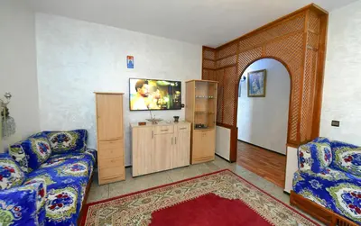 a living room with a couch and a tv at Dar Lamine Duplex in Rabat