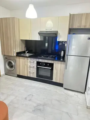 a kitchen with a refrigerator and a stove at Appartement confortable au corniche in Mohammedia