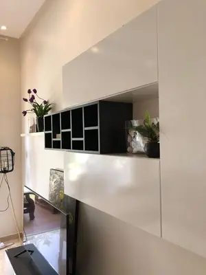 a room with a white wall with a mirror at Appartement moderne CASABAY BEACH Sidi Rahal in Sidi Rahal