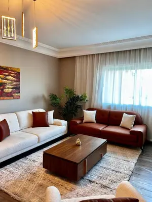 a living room with two couches and a coffee table at 3 minutes de casa voyageurs in Casablanca