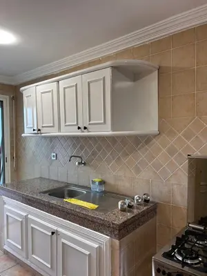 a kitchen with white cabinets and a sink at 3 minutes de casa voyageurs in Casablanca