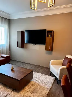a living room with a flat screen tv on the wall at 3 minutes de casa voyageurs in Casablanca