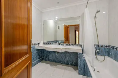 a bathroom with a tub and a sink and a mirror at TT Holidays 3BR Racine Casablanca in Casablanca