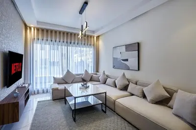 a living room with a couch and a table at Your Home Away from Home 2 Bed Flat With Parking in Casablanca