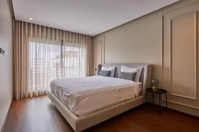 a bedroom with a large bed and a large window at Discover Casablanca Stay in our 3-Bed Gem with Parking in Casablanca