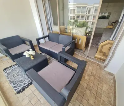 a living room with two chairs and a couch at superbe appartement vue piscine in Bouznika