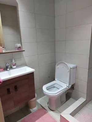 a bathroom with a toilet and a sink at Dahlia Sidi rahal in Sidi Rahal
