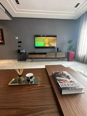 a living room with a flat screen tv on a wall at Luxury Maarif Anfa Racine in Casablanca