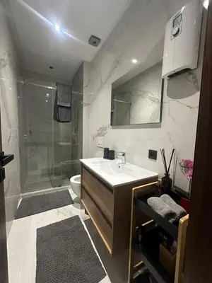 a bathroom with a sink and a shower at Luxury Maarif Anfa Racine in Casablanca