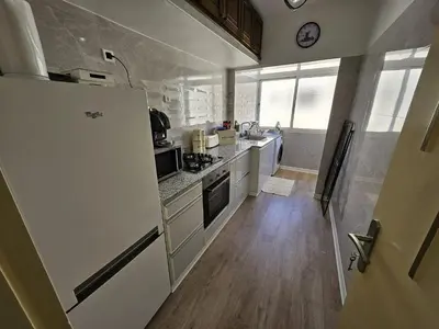a kitchen with a white refrigerator and a wooden floor at Cosy and Complete Casa appartment in Casablanca