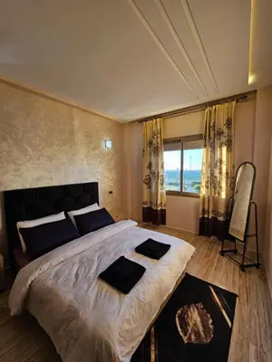 a bedroom with a large bed and a large window at MIA Appartement N1 - Élégance, Confort et Sérénité in Casablanca