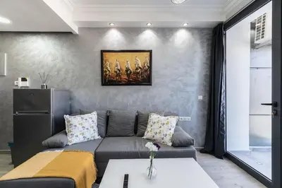 a living room with a couch and a painting on the wall at Stylish Studio à Ain Sebaa in Casablanca