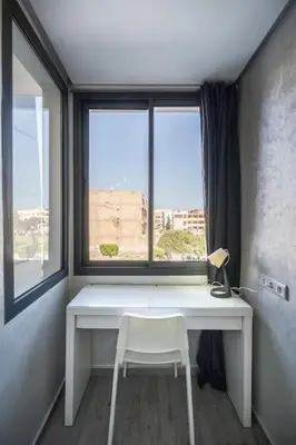 a white desk with a chair in front of a window at Stylish Studio à Ain Sebaa in Casablanca
