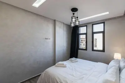 a bedroom with a white bed with towels on it at Chic Apartment Cosy Stay in Casablanca