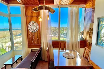 a dining room with a table and a large window at Fabulous Apartment Beach view in Mohammedia