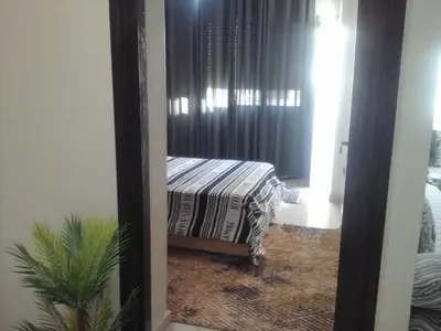 a room with a bed in a room with a window at Appartement Bourgogne casa Anfa in Casablanca