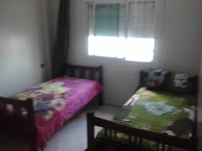 a bedroom with a twin bed and a window at Appartement Bourgogne casa Anfa in Casablanca