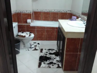 a bathroom with dogs laying on the floor at Appartement Bourgogne casa Anfa in Casablanca