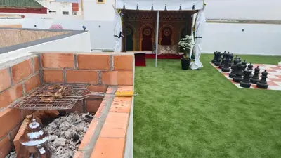 a backyard with a chess board and a grill at Camping on the rooftop close to Casablanca Airport in Dah Hammou Ben Cheïkh