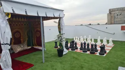 a giant chess set on a lawn with a tent at Camping on the rooftop close to Casablanca Airport in Dah Hammou Ben Cheïkh