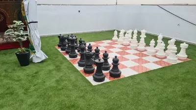 a chess board on a lawn with a giant chessboard at Camping on the rooftop close to Casablanca Airport in Dah Hammou Ben Cheïkh